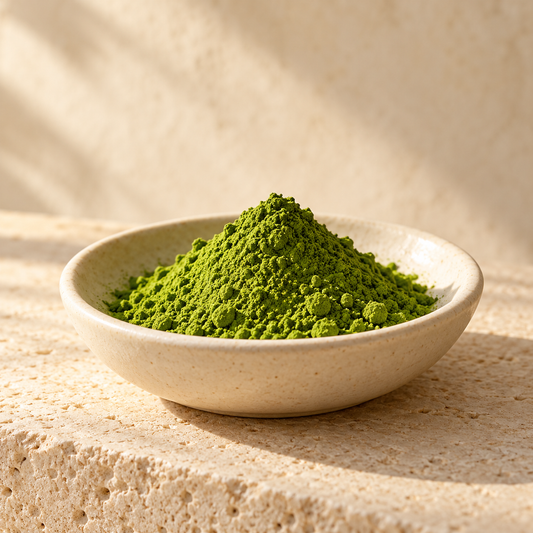 a small mound of bright green matcha powder in an ivory dish