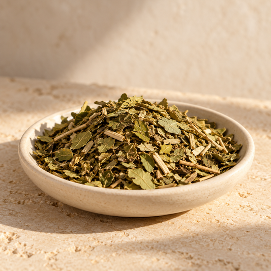 dried yerba mate leaves in a shallow ivory dish