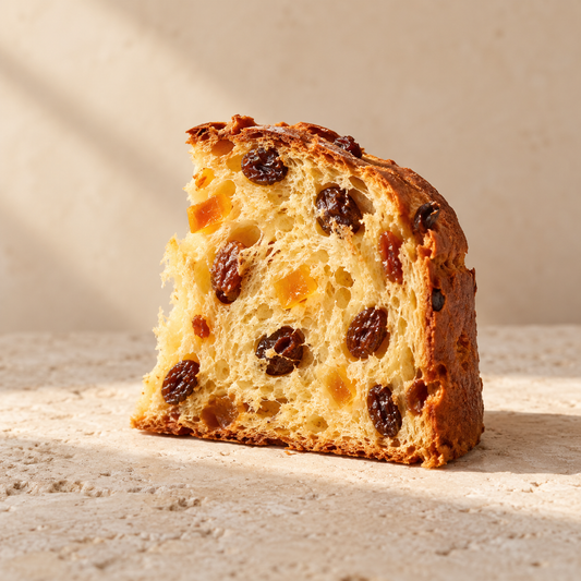 a small slice of panettone showing raisins and candied peel