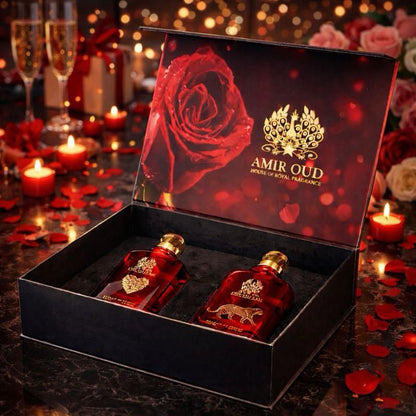 Two red perfume bottles in a decorative box with 'Amir Oud' branding, surrounded by candles and rose petals.