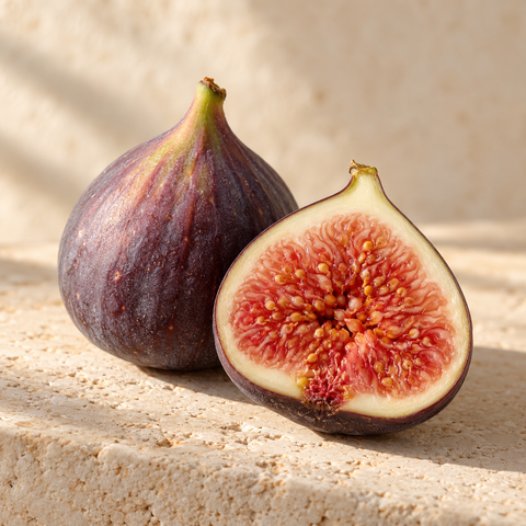 one purple fig and a cut half showing rosy seeds