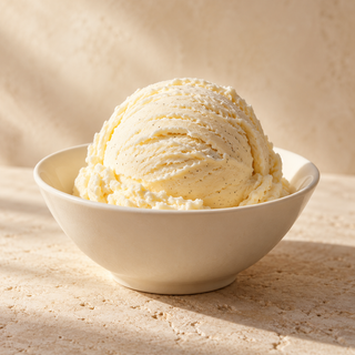a single scoop of plain vanilla ice cream in an ivory dish
