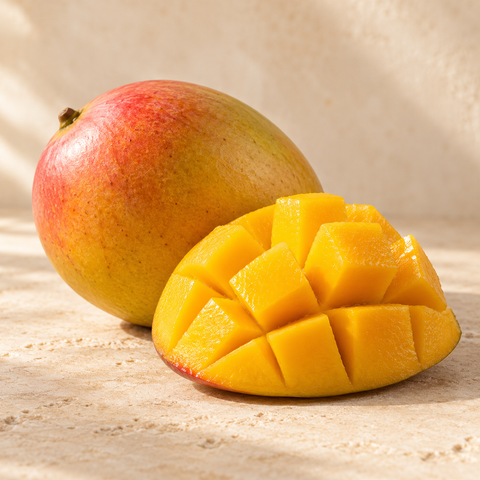 a ripe mango and a cut golden mango cheek