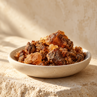 reddish-brown myrrh resin pieces in a shallow ivory dish