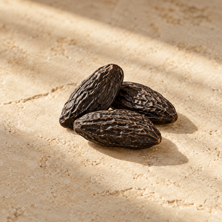three dark wrinkled tonka beans