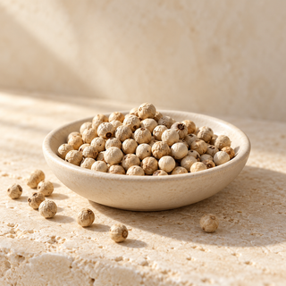 pale white peppercorns in a shallow ivory dish